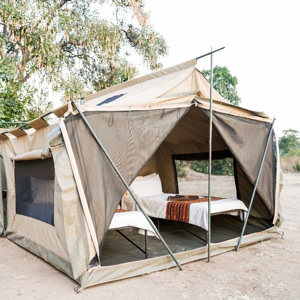 A canvas safari tent with bed and open front at Chitake Mobile Camp, Mana Pools
