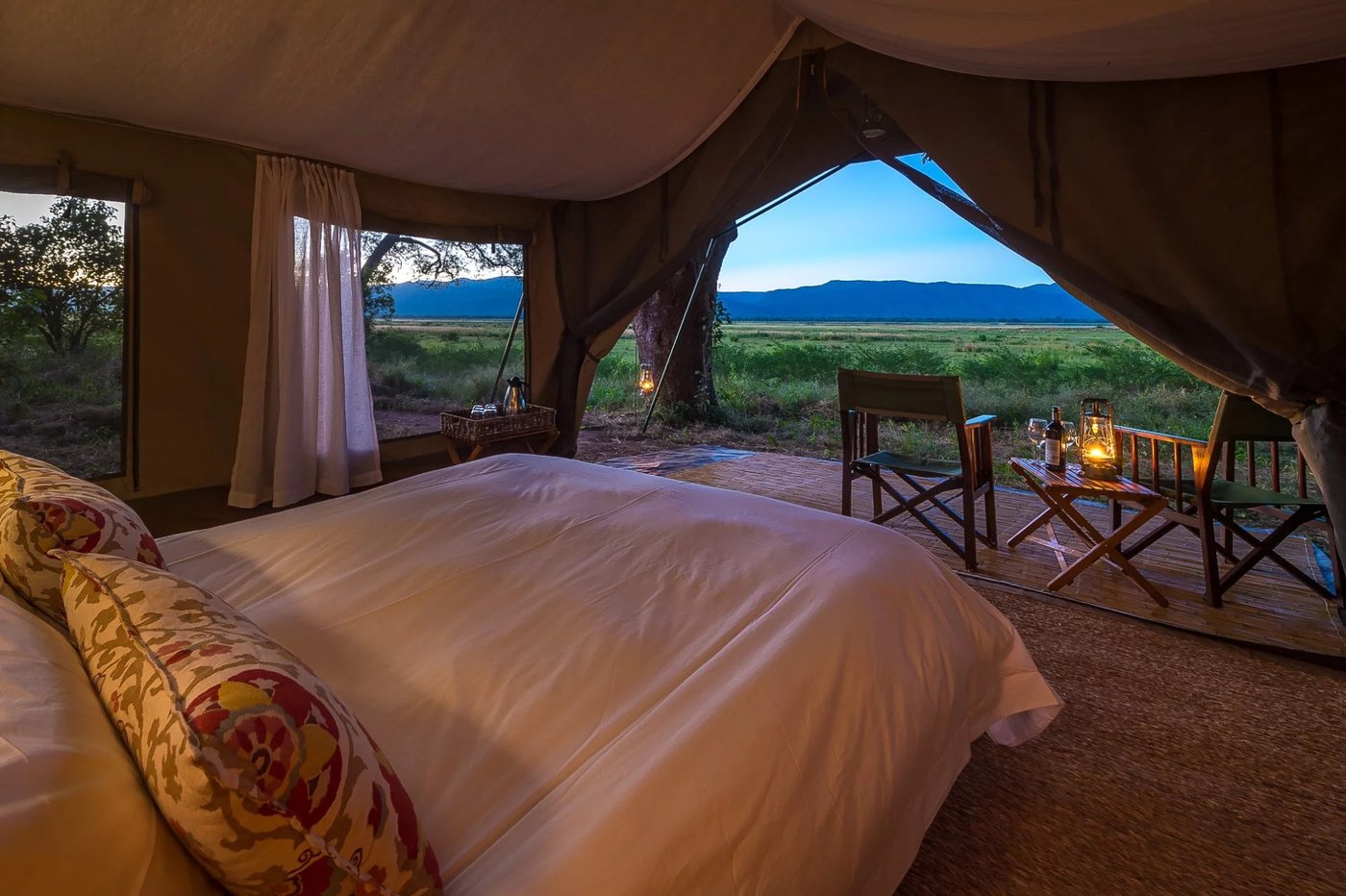 Tent bedroom framing a view of the floodplain at John's Camp.