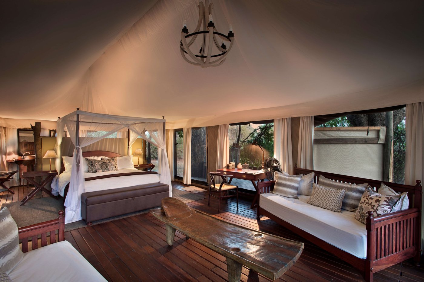 Four-poster bedroom with soft lighting at Kanga Expeditions.