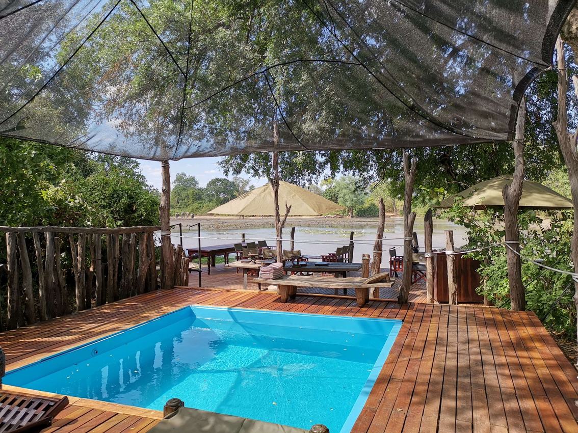 Swimming pool deck shaded by a canvas canopy at Kanga Expeditions.