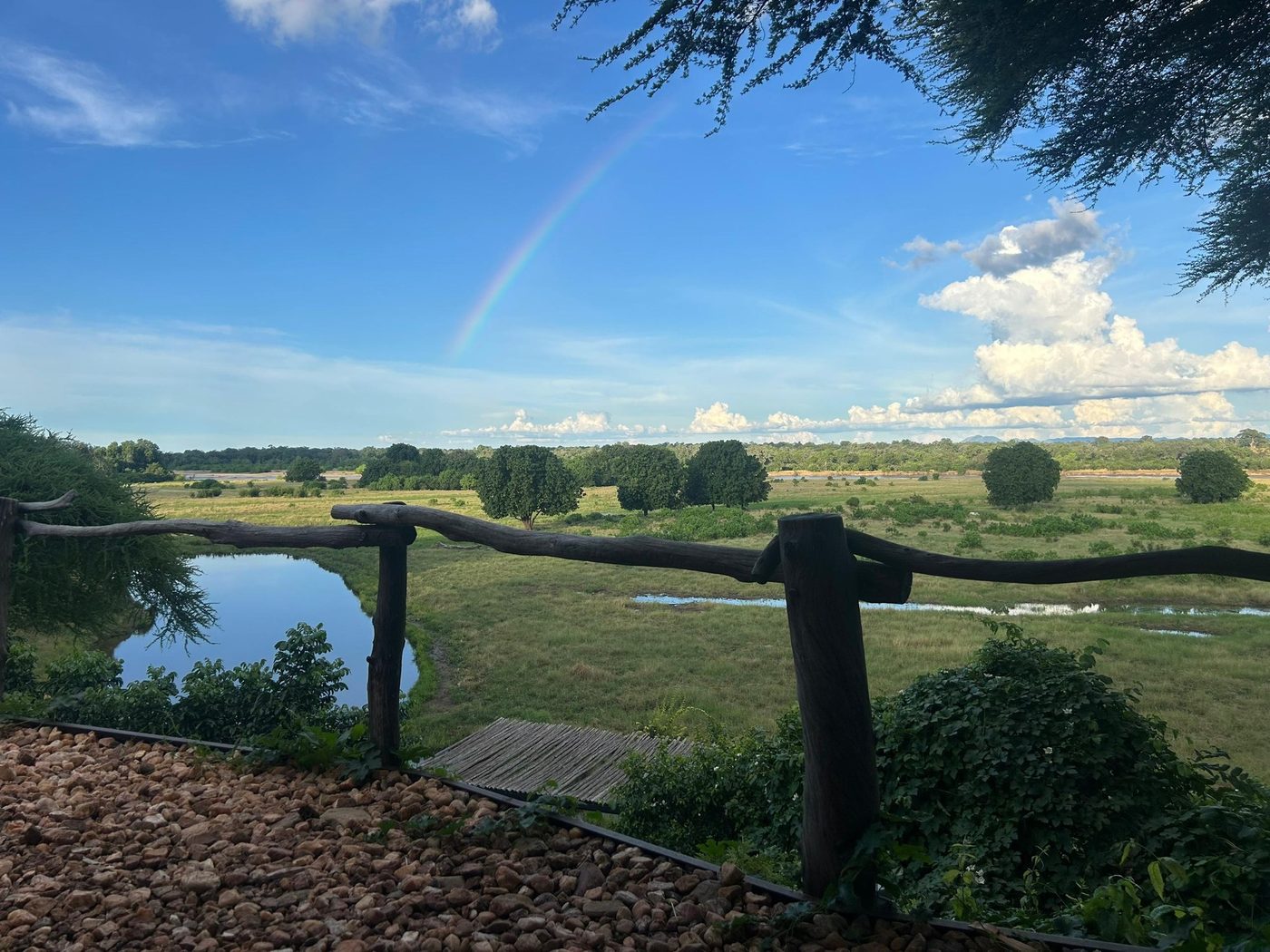 Deck view of the floodplain under a rainbow at Kavinga Safari Camp.