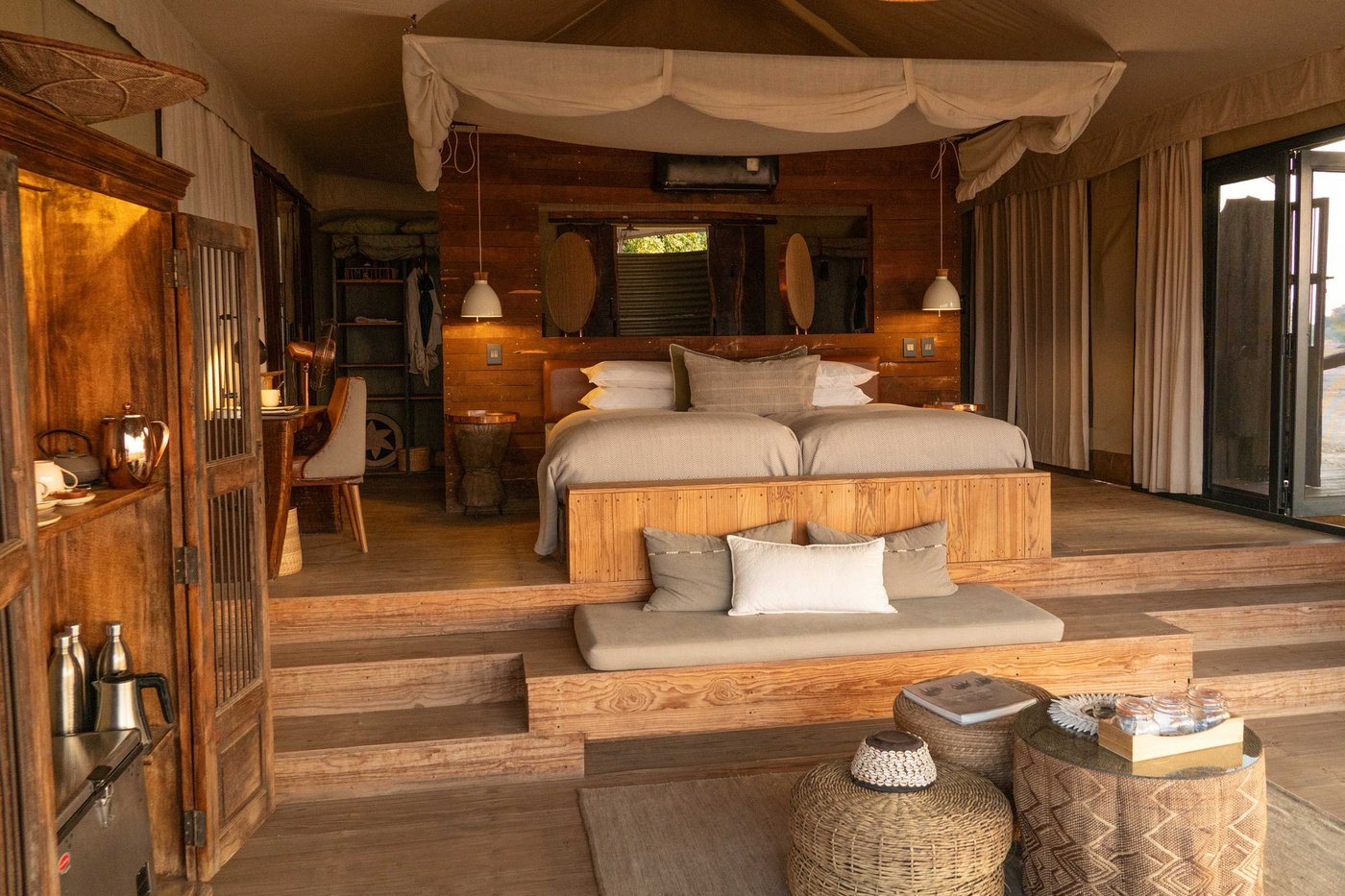 Twin bedroom with wooden furniture and soft lighting at Nyamatusi Mahogany.