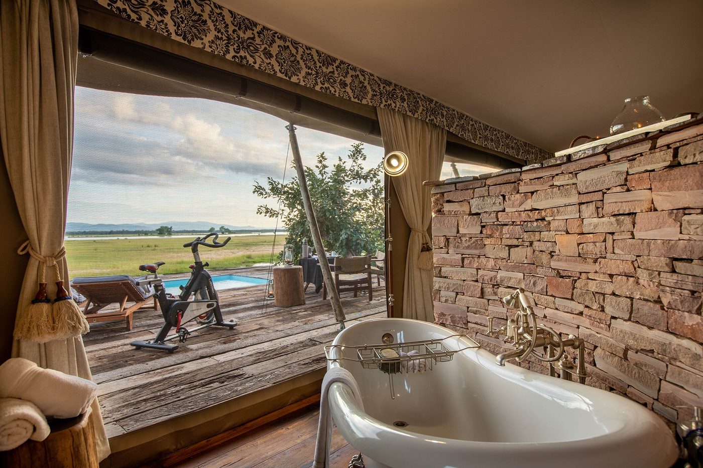 Tent suite with an outdoor bath and floodplain view at Tembo Plains Camp.