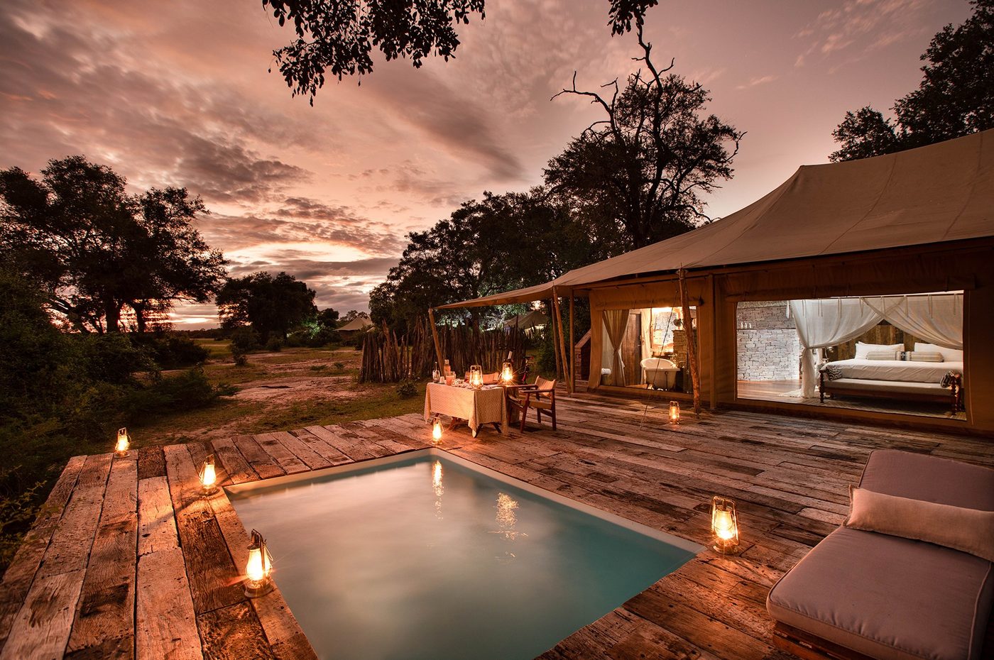 Private plunge pool deck with wooden loungers at Tembo Plains Camp.