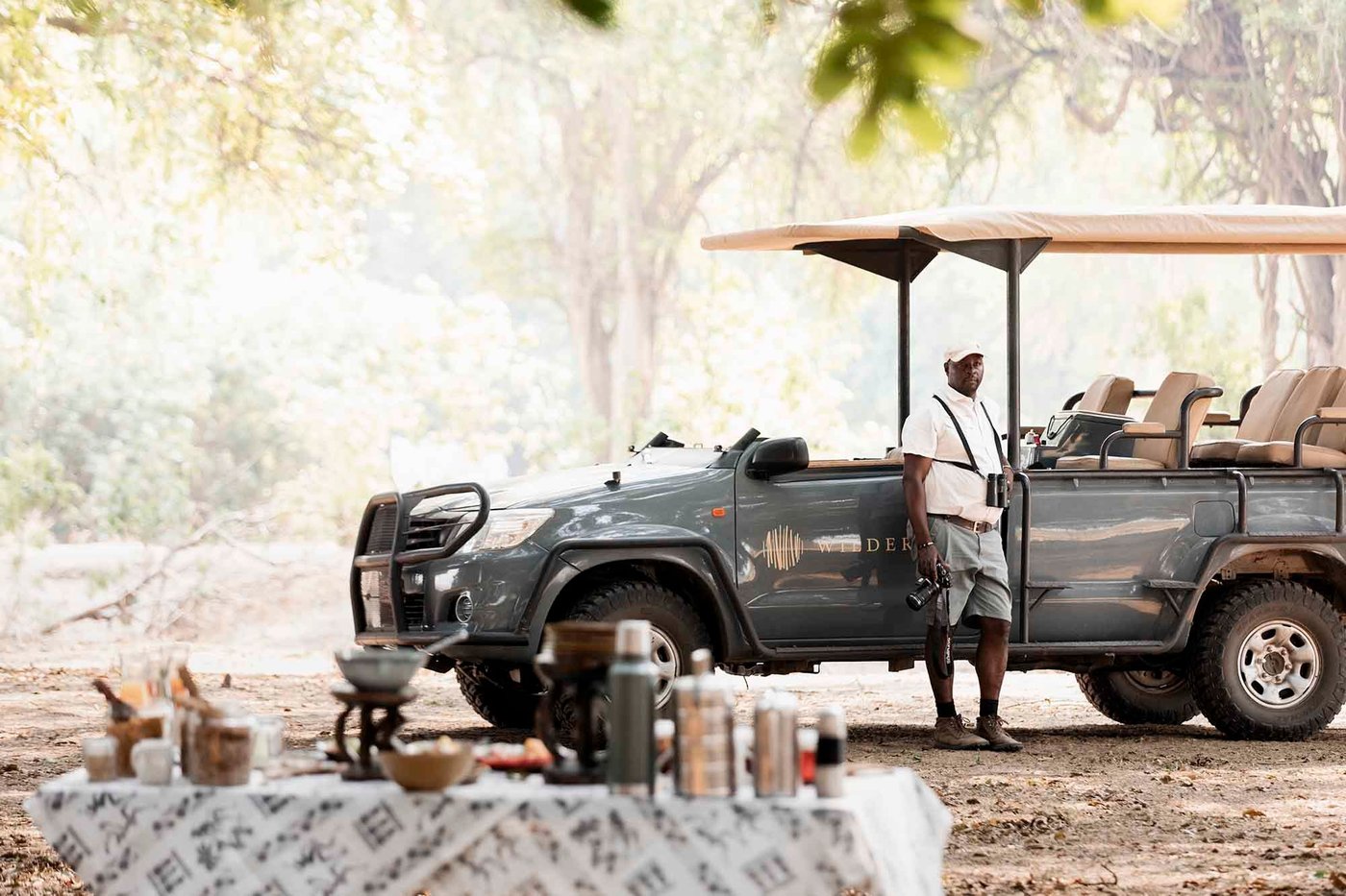 Safari vehicle stopped for a bush coffee break at Wilderness Ruckomechi.